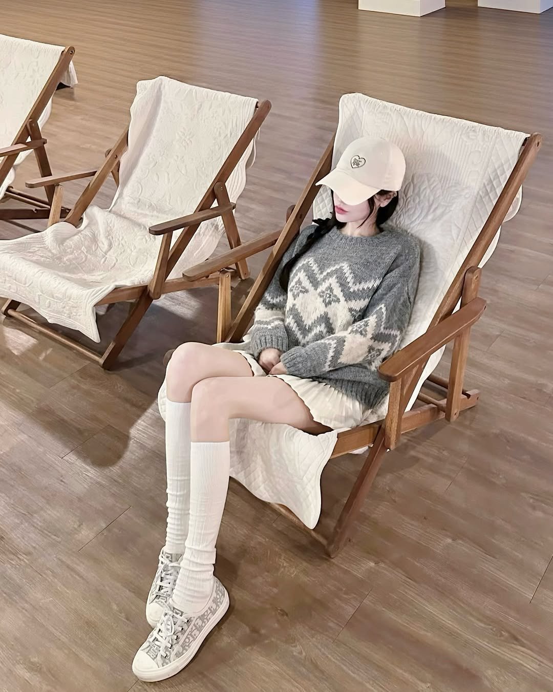 Photo shared by 숨니 on February 17, 2026 tagging @toospit. May be an image of hat, armchair, deck chair, rocking chair, chair, chaise lounge and text.