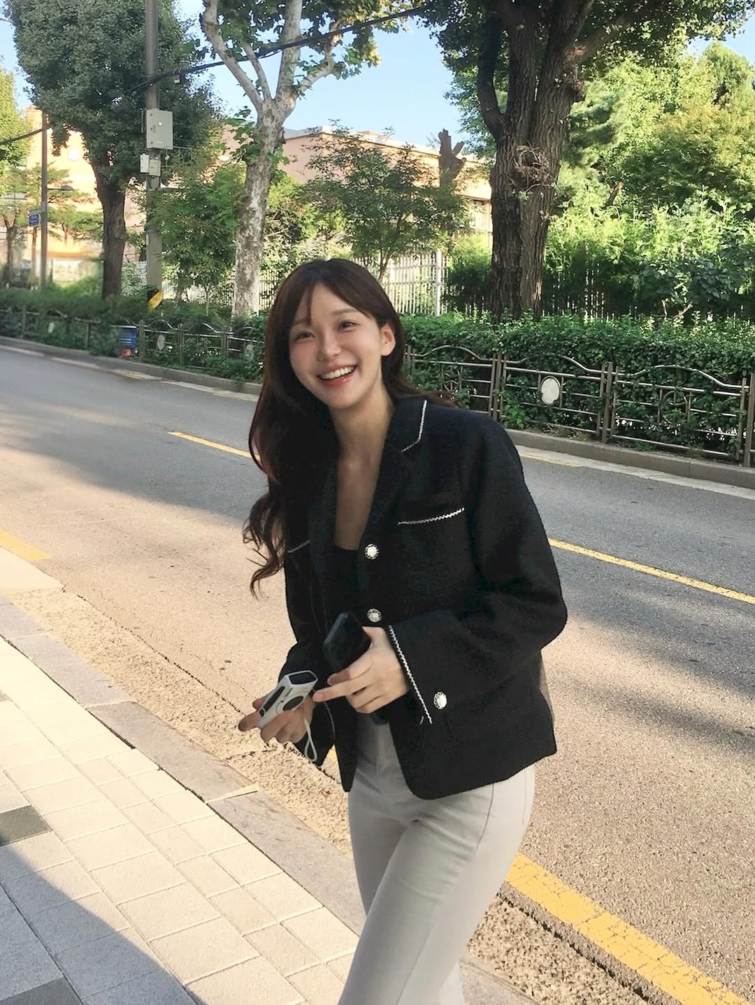 Photo shared by 김윤희 아나운서 on September 30, 2025 tagging @marduk__luv_it, and @marduk_official. May be an image of 1 person, smiling, jacket, road, street and text.