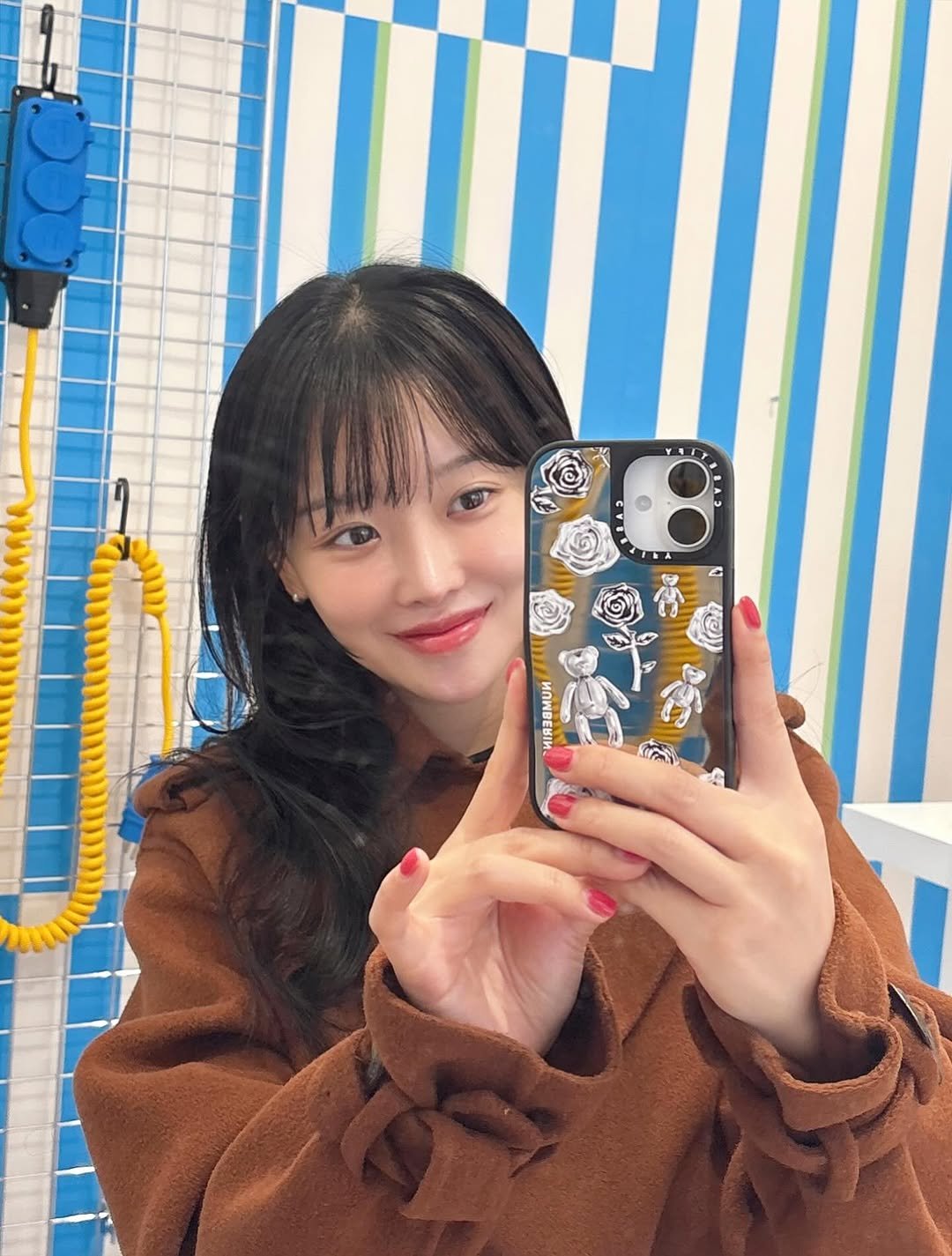 Photo shared by 임재원 on November 18, 2025 tagging @casetify, @numbering_official, and @casetify_kr. May be a selfie of one or more people, hair, duffle coat, phone, top, parka, mirror and text.