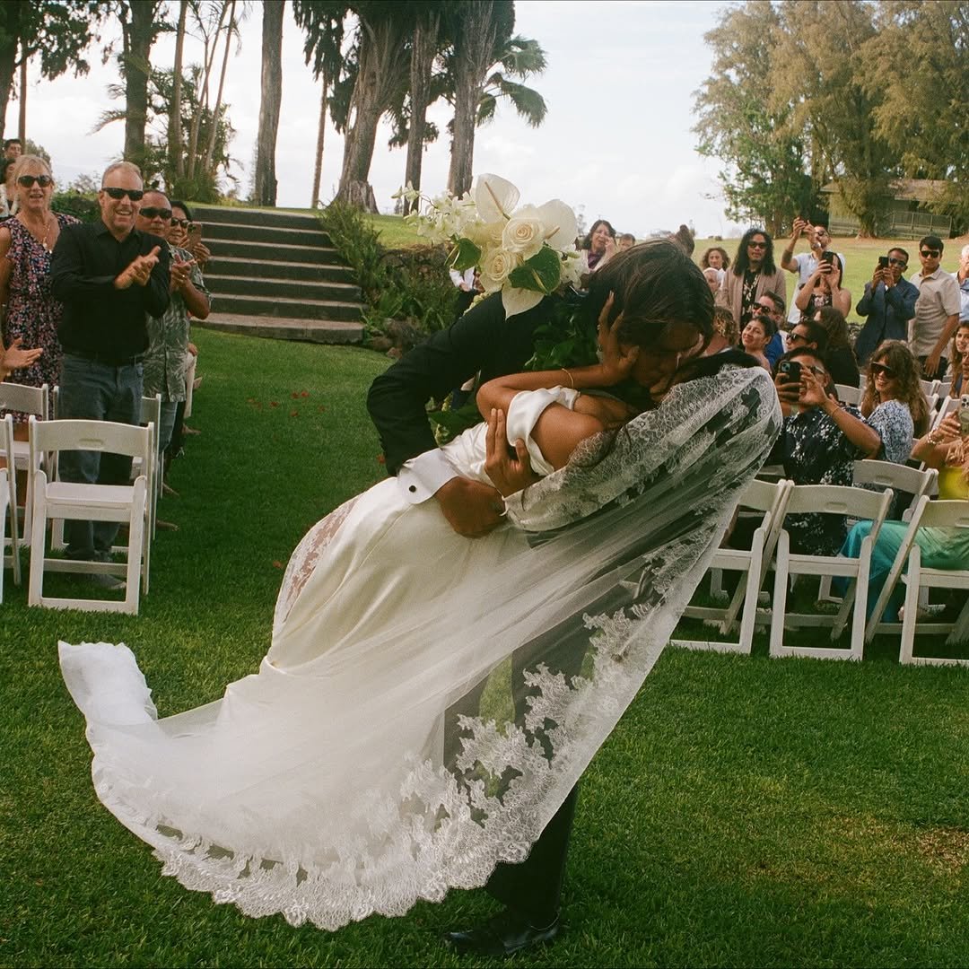 Photo shared by Imaikalani deVault on November 14, 2025 tagging @neisha_. May be an image of people kissing, wedding and text.