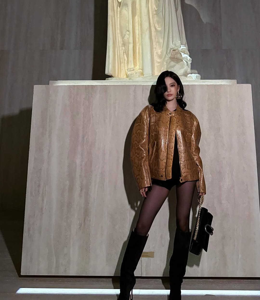 Photo shared by NINGNING on March 02, 2026 tagging @gucci. May be an image of overcoat, turtleneck, the Parthenon, statue and text.