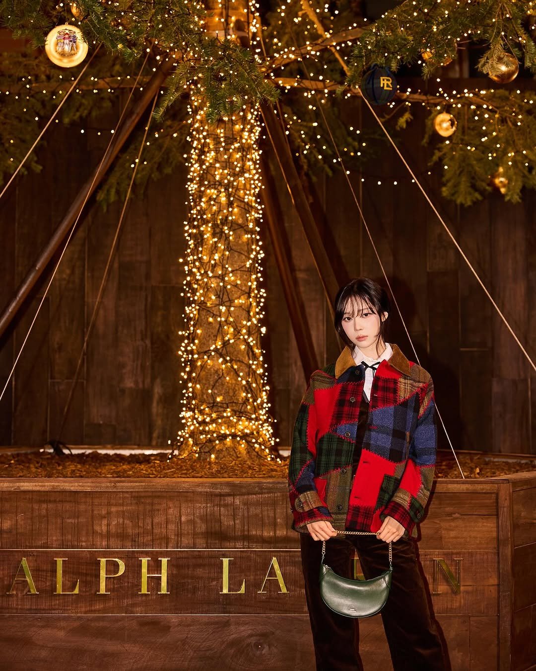 Photo shared by WINTER on October 31, 2025 tagging @ralphlauren, and @poloralphlauren. May be an image of christmas tree, duffle coat, tinsel, poster and text that says 'LPHLA LPH LA'.
