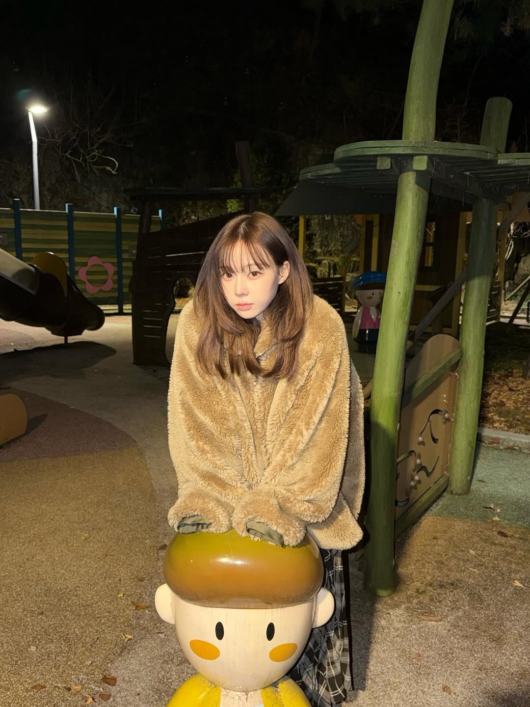 Photo by WINTER on December 26, 2025. May be an image of child, duffle coat, fur, slide, turtleneck, parka, park and text.