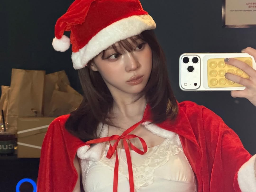 Photo by WINTER on December 25, 2025. May be a selfie of one or more people, hair, phone, bath robe, costume and text.