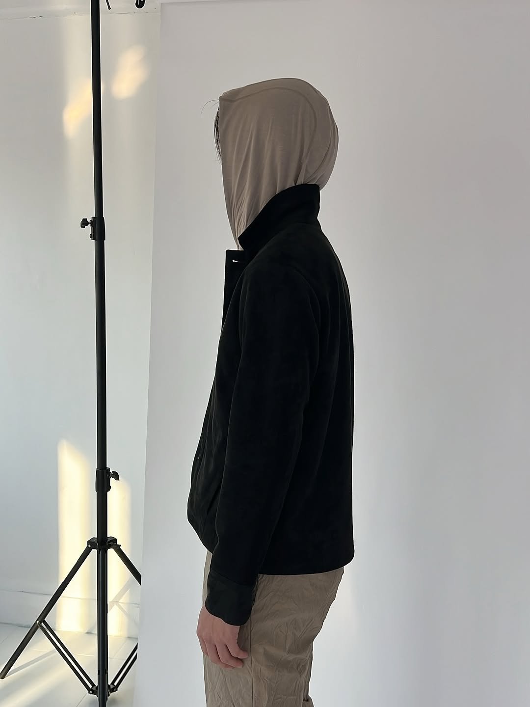 Photo by Inside the Emotion on November 18, 2025. May be an image of standing, tripod, cloak, parka, face mask and text.