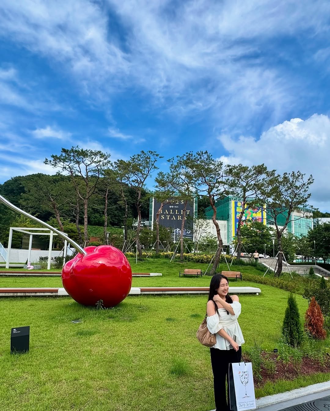 Photo by isol choe • 최이솔 on July 20, 2025. May be an image of 2 people, cloud, park and text.