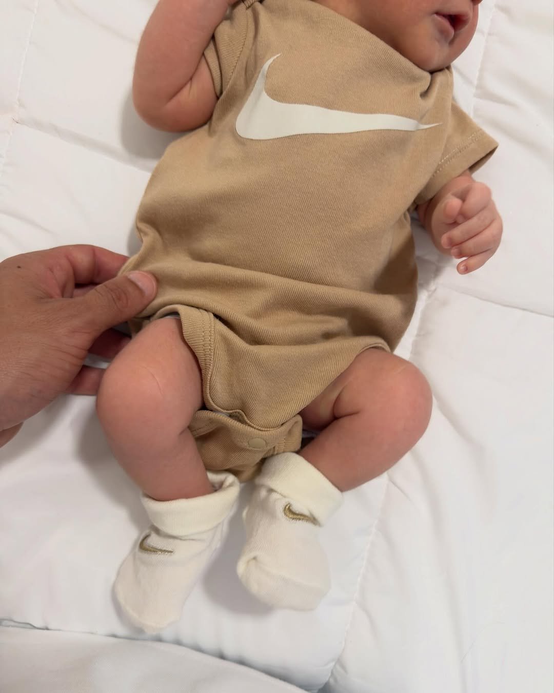 Photo by Italo Ferreira on January 12, 2026. May be an image of baby, baby shoes and text.