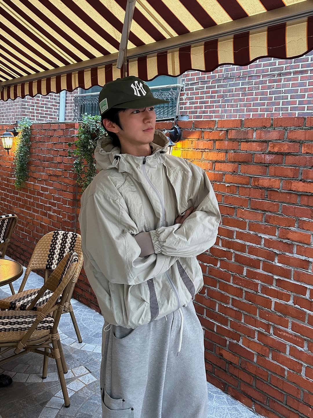 Photo by 정재훈 | CAON on September 21, 2025. May be an image of 1 person, overcoat, duffle coat, hat, jacket, military uniform, raincoat, parka and text.
