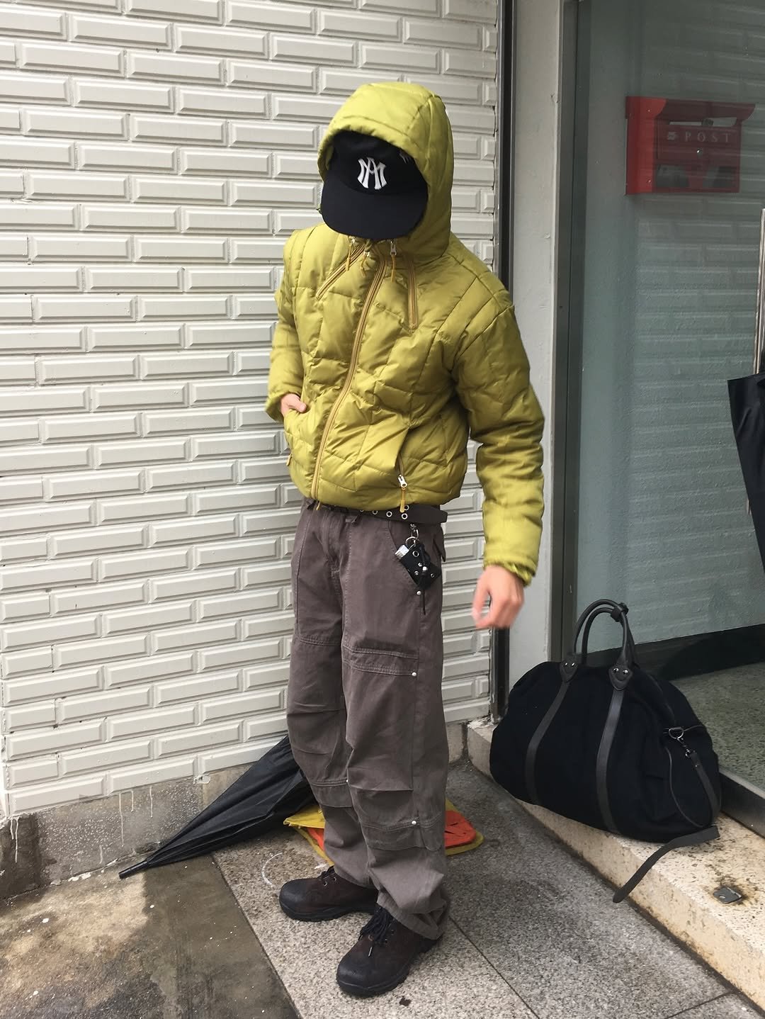 Photo by 정재훈 | CAON on December 16, 2025. May be an image of duffle coat, goosedown coat, face mask, raincoat, parka and text.