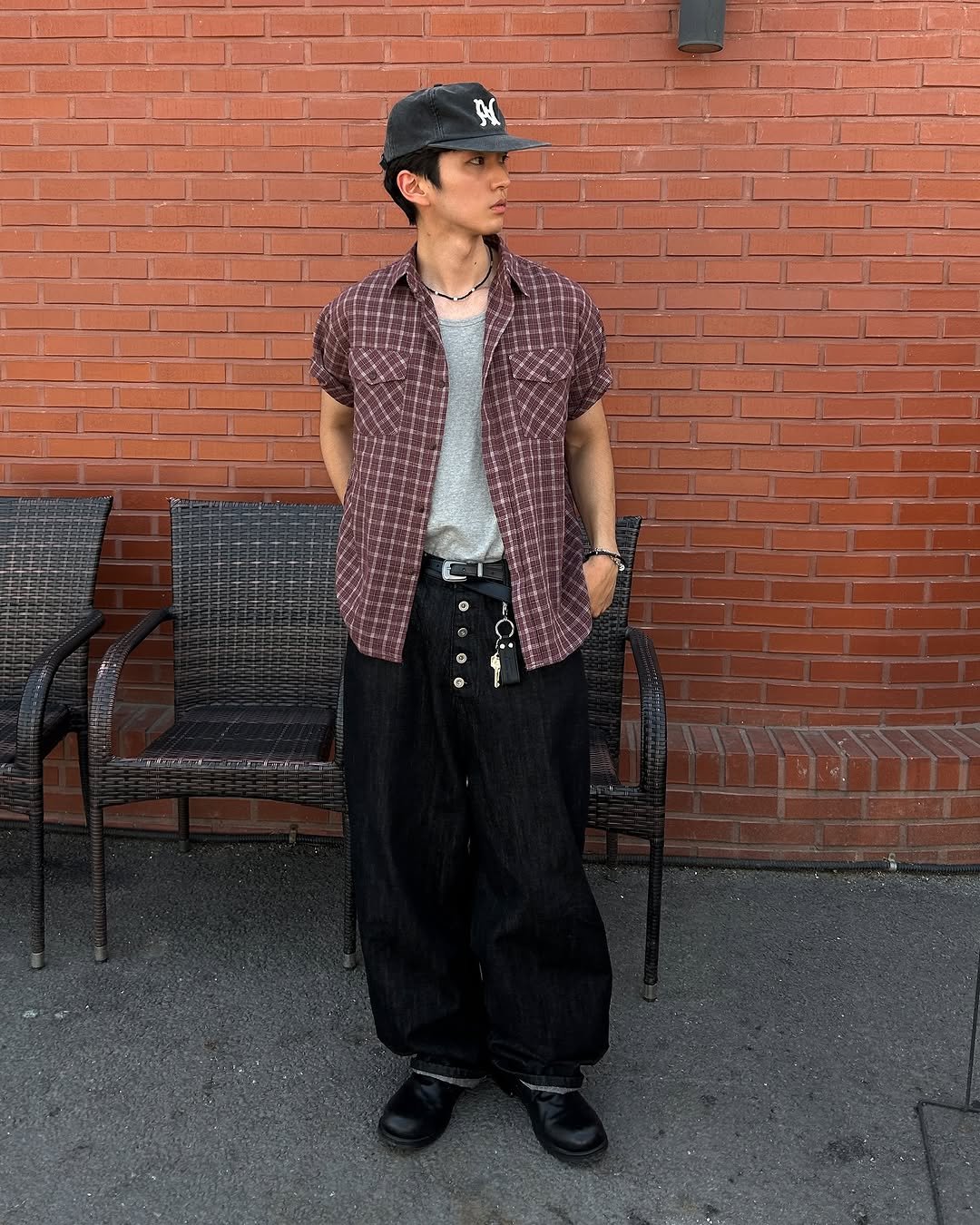 Photo by 정재훈 | CAON on July 20, 2025. May be an image of 1 person, outerwear, brick wall and text.