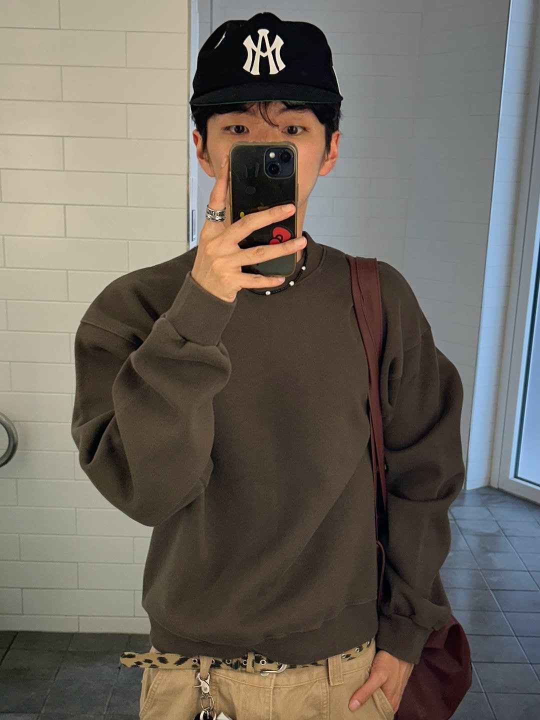 Photo by 정재훈 | CAON on September 30, 2025. May be an image of 1 person, duffle coat, hat, parka, sweater, sweatpants and text.