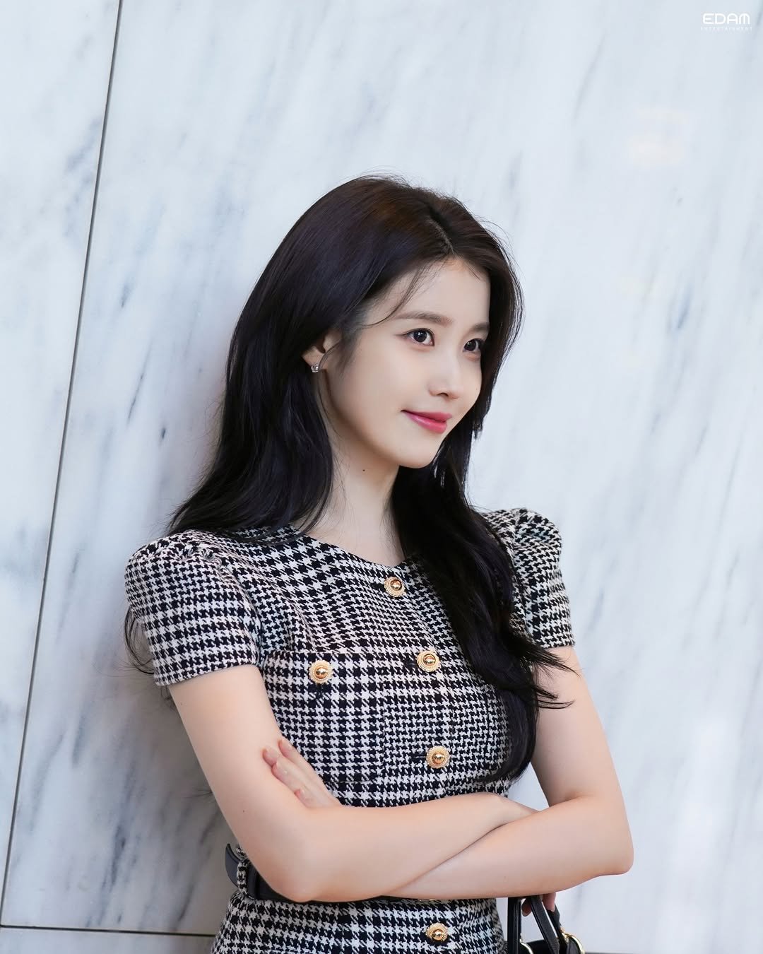Photo shared by 아이유(IU) on April 19, 2026 tagging @dlwlrma. May be an image of one or more people, hair, top and text that says 'EDAM'.
