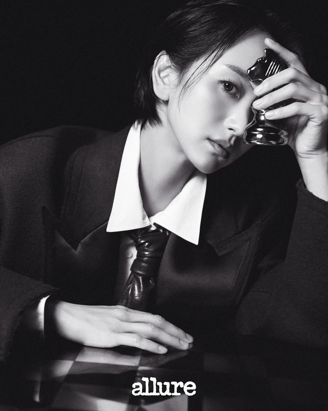 Photo by 원진아 on December 21, 2025. May be a black-and-white image of one or more people, hair, blazer, bolo tie, top and text that says 'allure'.