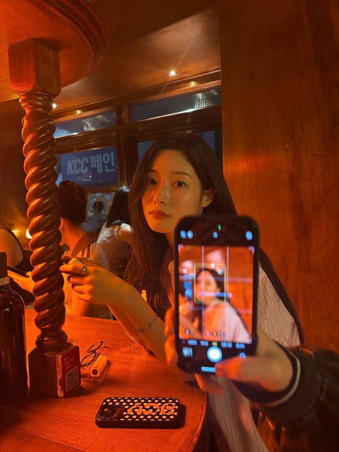 Photo by 정채연 on November 14, 2025. May be an image of phone, mirror, night and text.