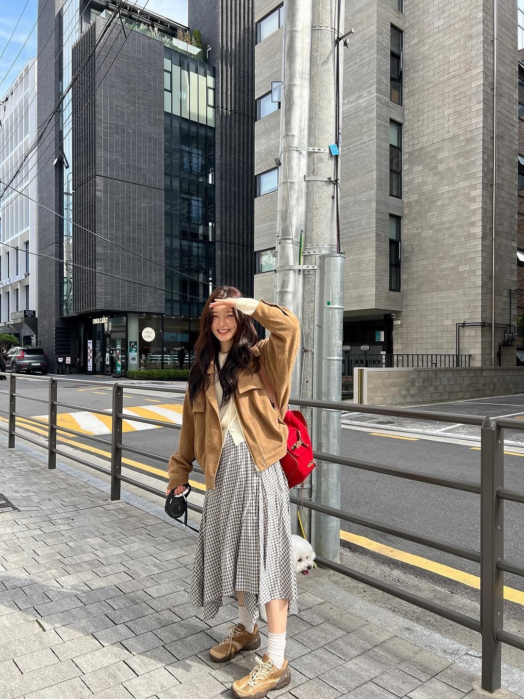 Photo shared by 정채연 on October 10, 2025 tagging @fila_korea. May be an image of street, skyscraper, buildings and text.