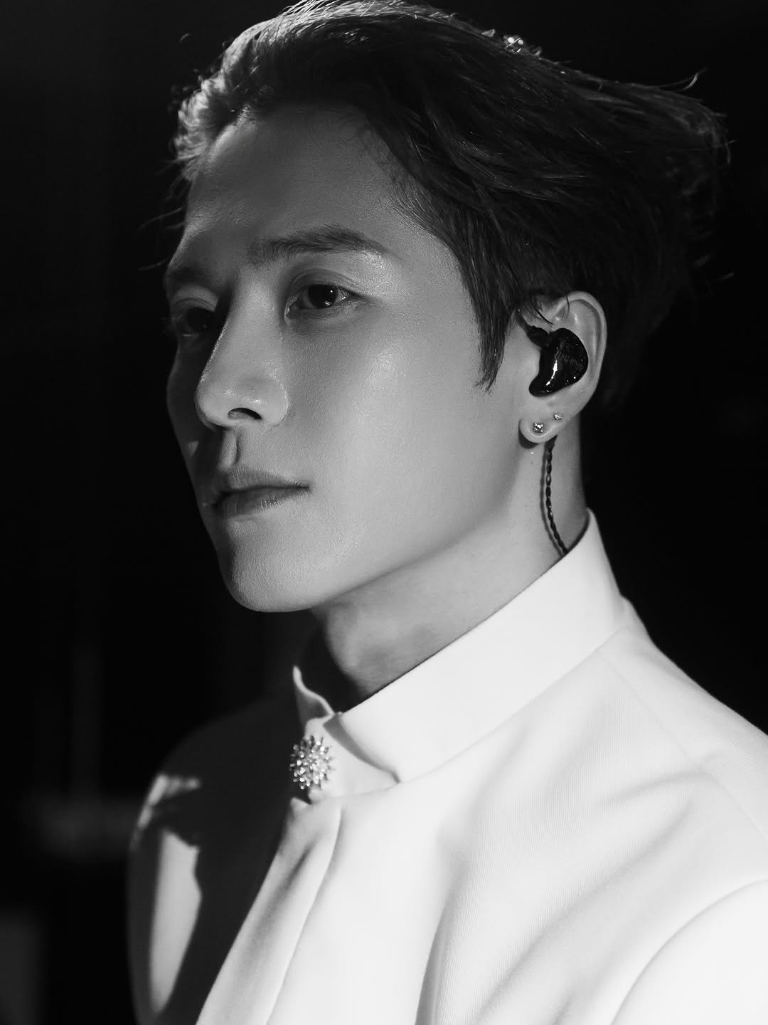 Photo by Jackson Wang on April 25, 2026. May be a black-and-white image of one or more people, bangs, bolo tie, top and text.