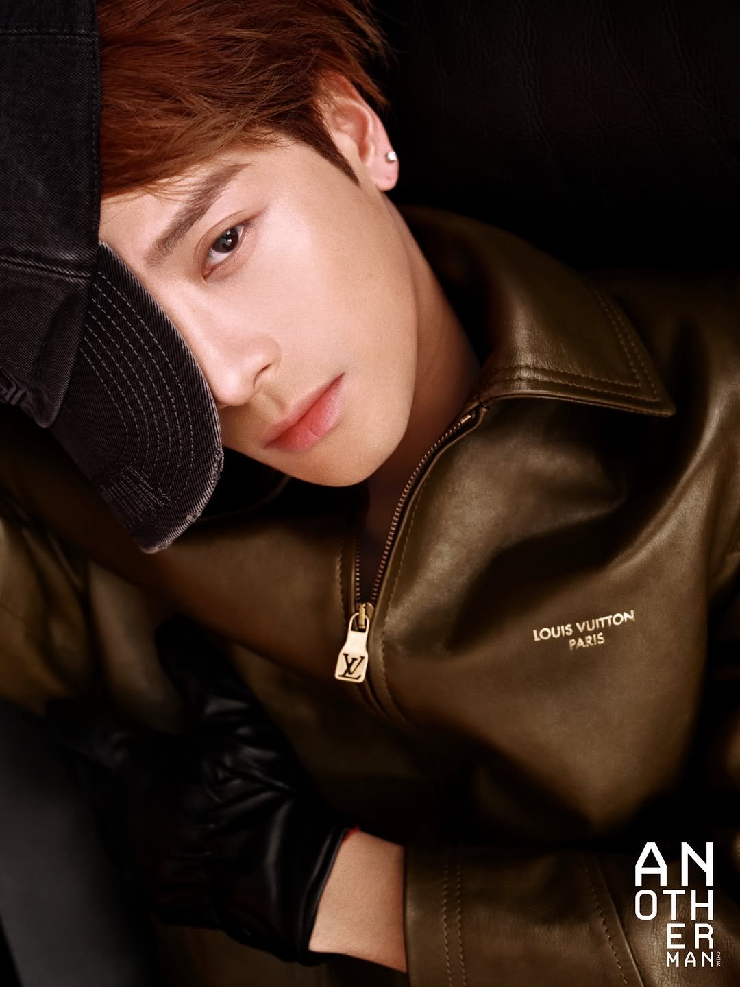 Photo by Jackson Wang on January 15, 2026. May be an image of one or more people, makeup, poster, bolo tie, magazine and text that says '비하학터 M LV LOUIS PARIS LOUISVUITTON IS VUITTON AN OTH ER MANI'.