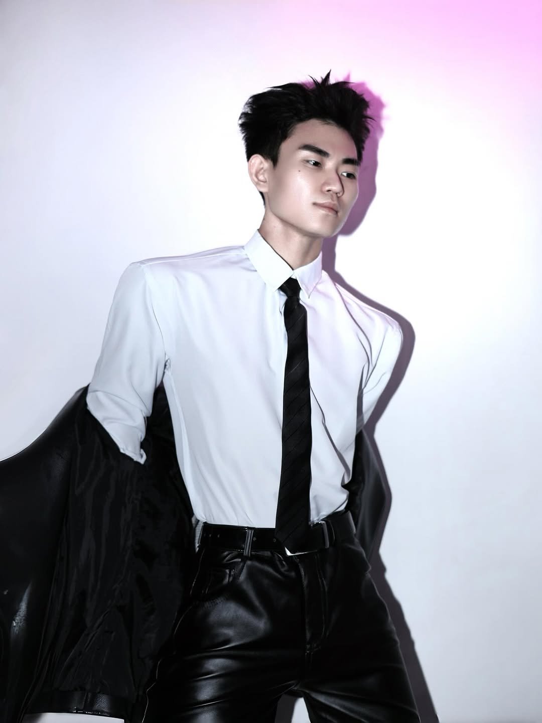 Photo by Trần Võ Nhật Kiên on April 27, 2026. May be an image of one or more people, makeup, suit, bolo tie, dinner jacket and text.