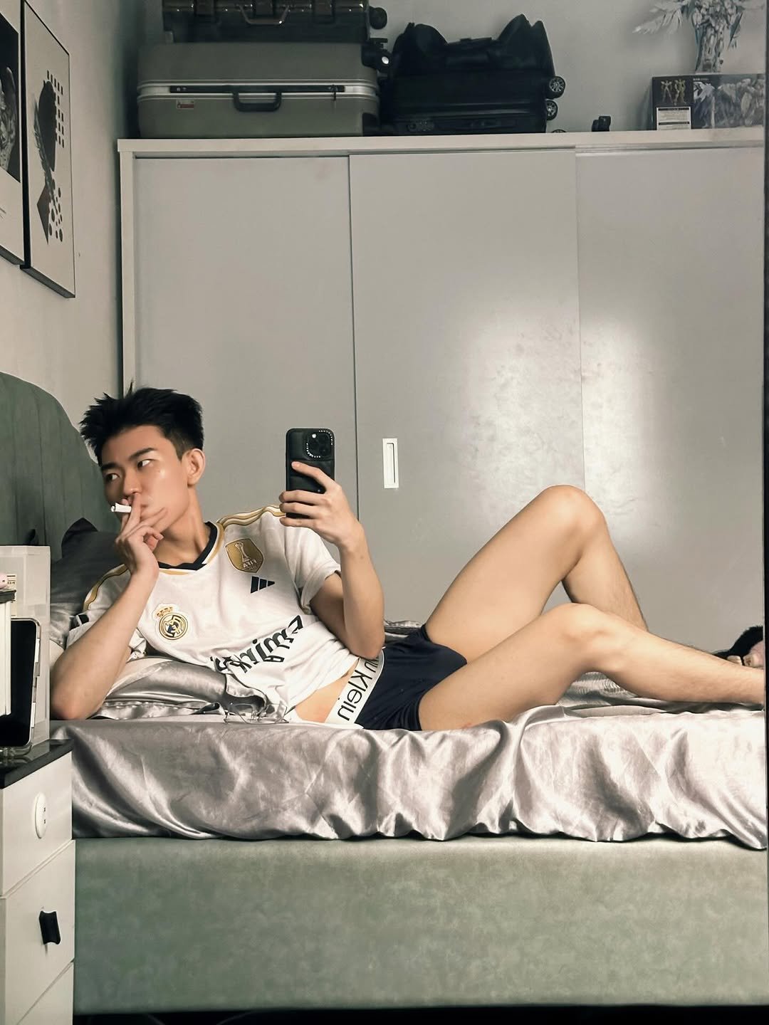 Photo by Trần Võ Nhật Kiên on April 15, 2026. May be an image of bed, mirror, shorts, bedroom and text.