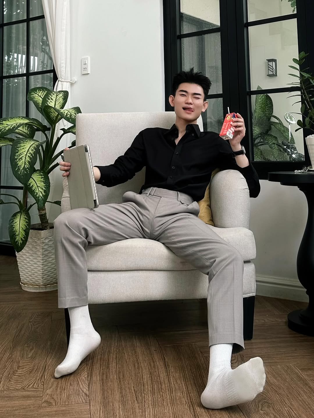 Photo by Trần Võ Nhật Kiên on April 25, 2026. May be an image of wingtip shoes, house plant, suit, sock and text.