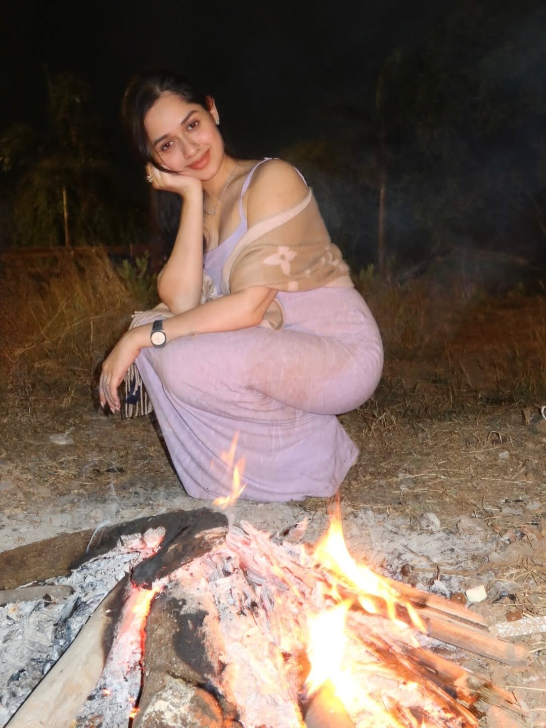 Photo by Jannat Zubair Rahmani on January 01, 2026. May be an image of smiling, fire, picnic, night and text.