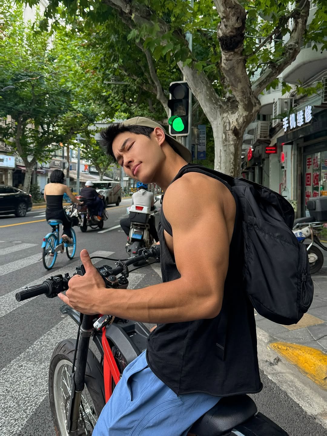 Photo by zhenhao_cai on September 13, 2025. May be an image of 2 people, biceps, bicycle, scooter, street and text.