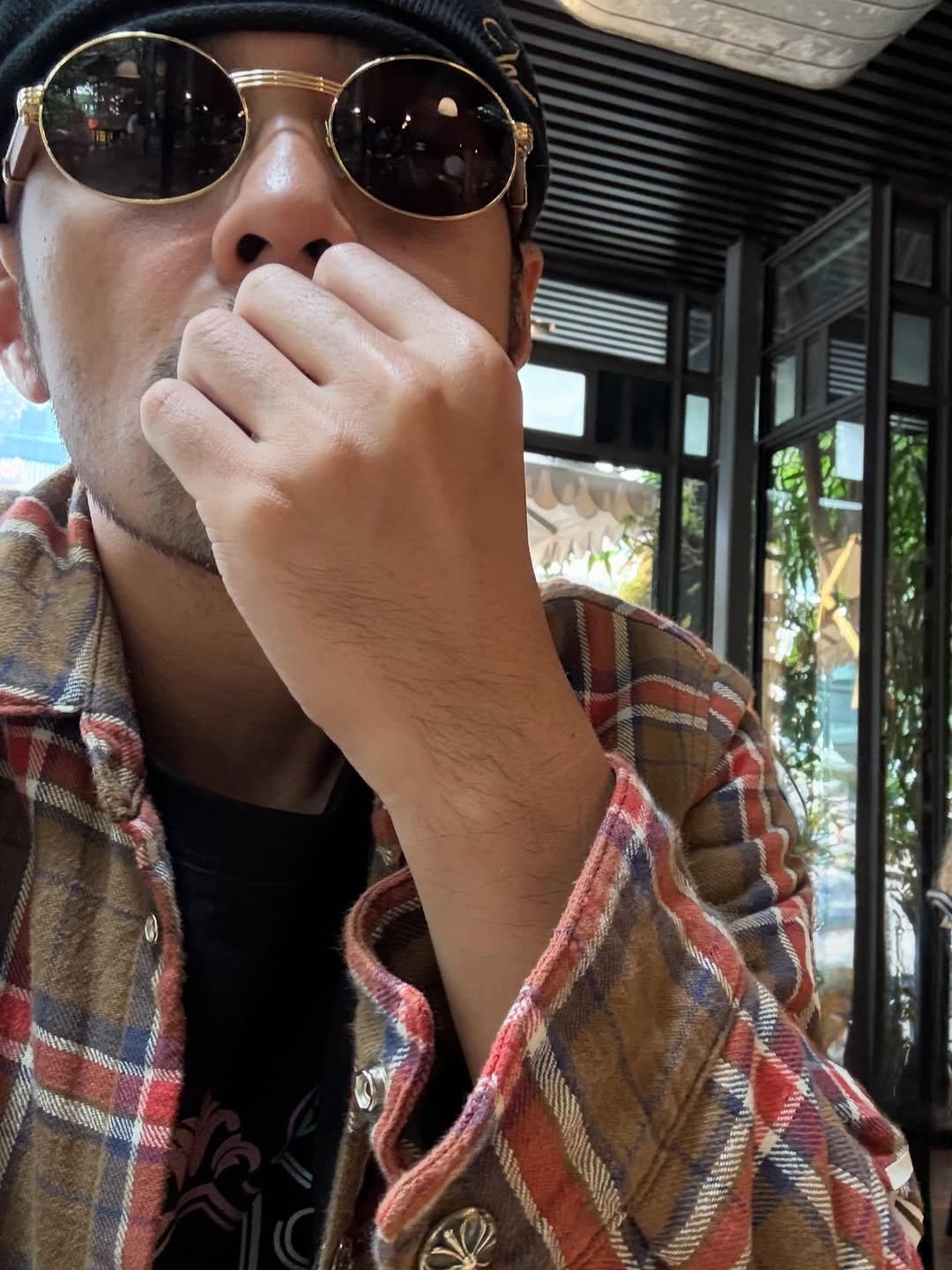 Photo by Jay Chou 周杰倫 on February 11, 2026. May be an image of eyewear, duffle coat, flannel, cigarette, beret and text.