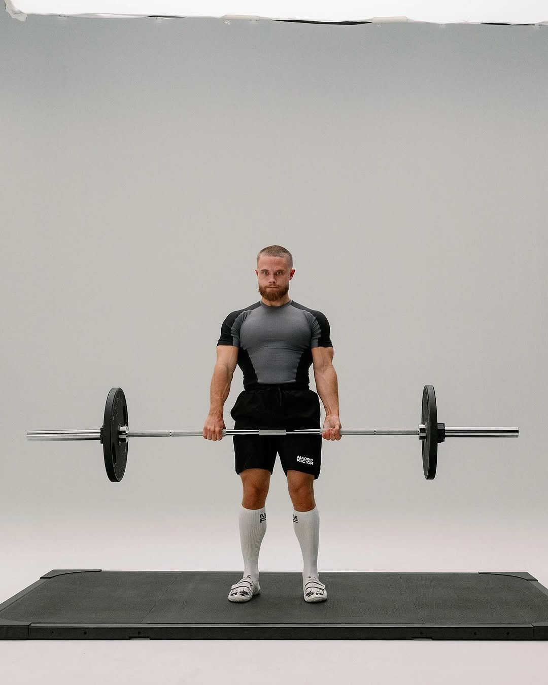 Photo shared by Jeff Nippard on December 30, 2025 tagging @tylorkc, and @macrofactorapp. May be an image of barbell, sportswear, dumbbell, rack and text.