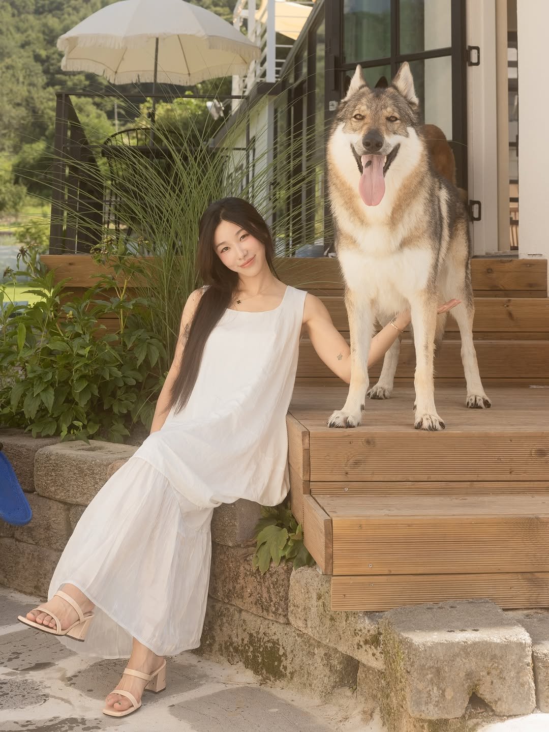 Photo by Camila & Jelly on August 10, 2025. May be an image of 1 person, wolf, Groenendael, sundress, outdoors and text.