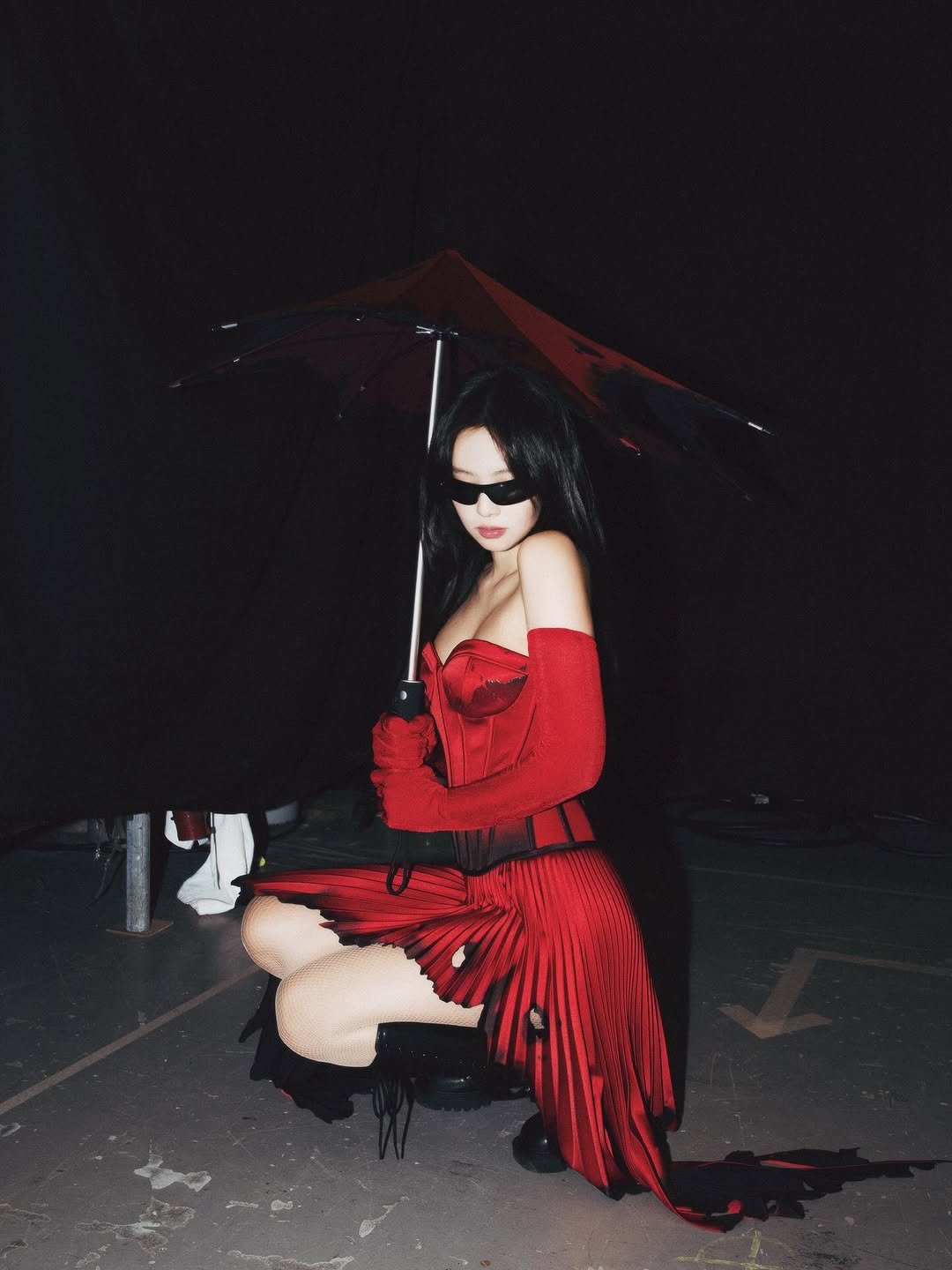 Photo by J on December 09, 2025. May be an image of fishnet stockings, parasol, umbrella and text.