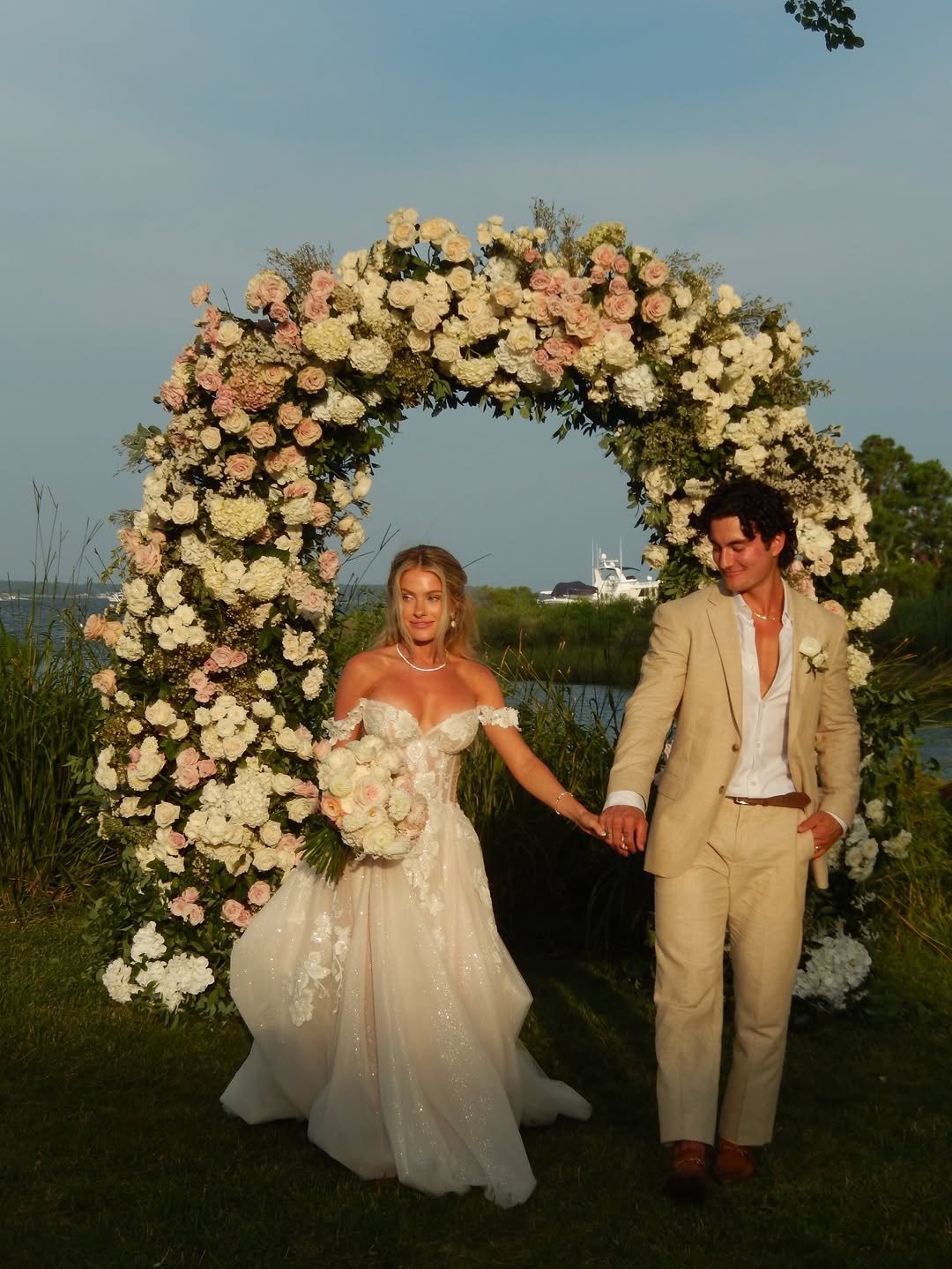 Photo by Jesse James West on December 31, 2025. May be an image of gown, flower, wedding and text.