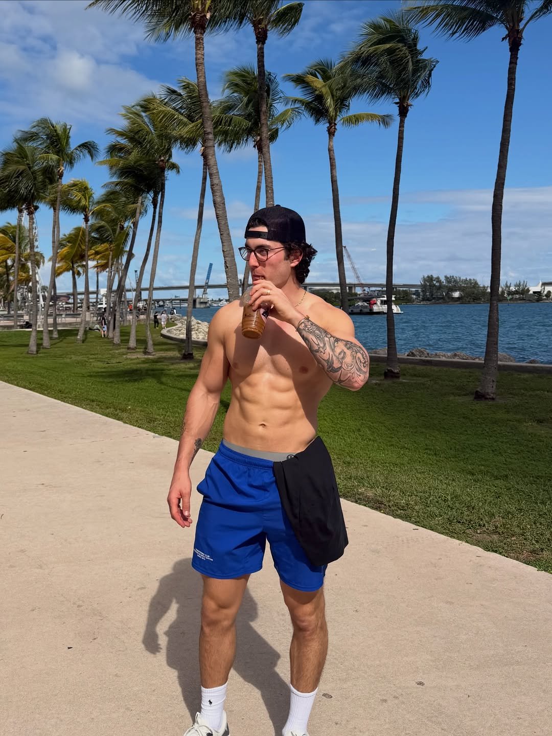 Photo by Jesse James West on January 09, 2026. May be an image of body building, activewear, sportswear, palm trees, park and text.