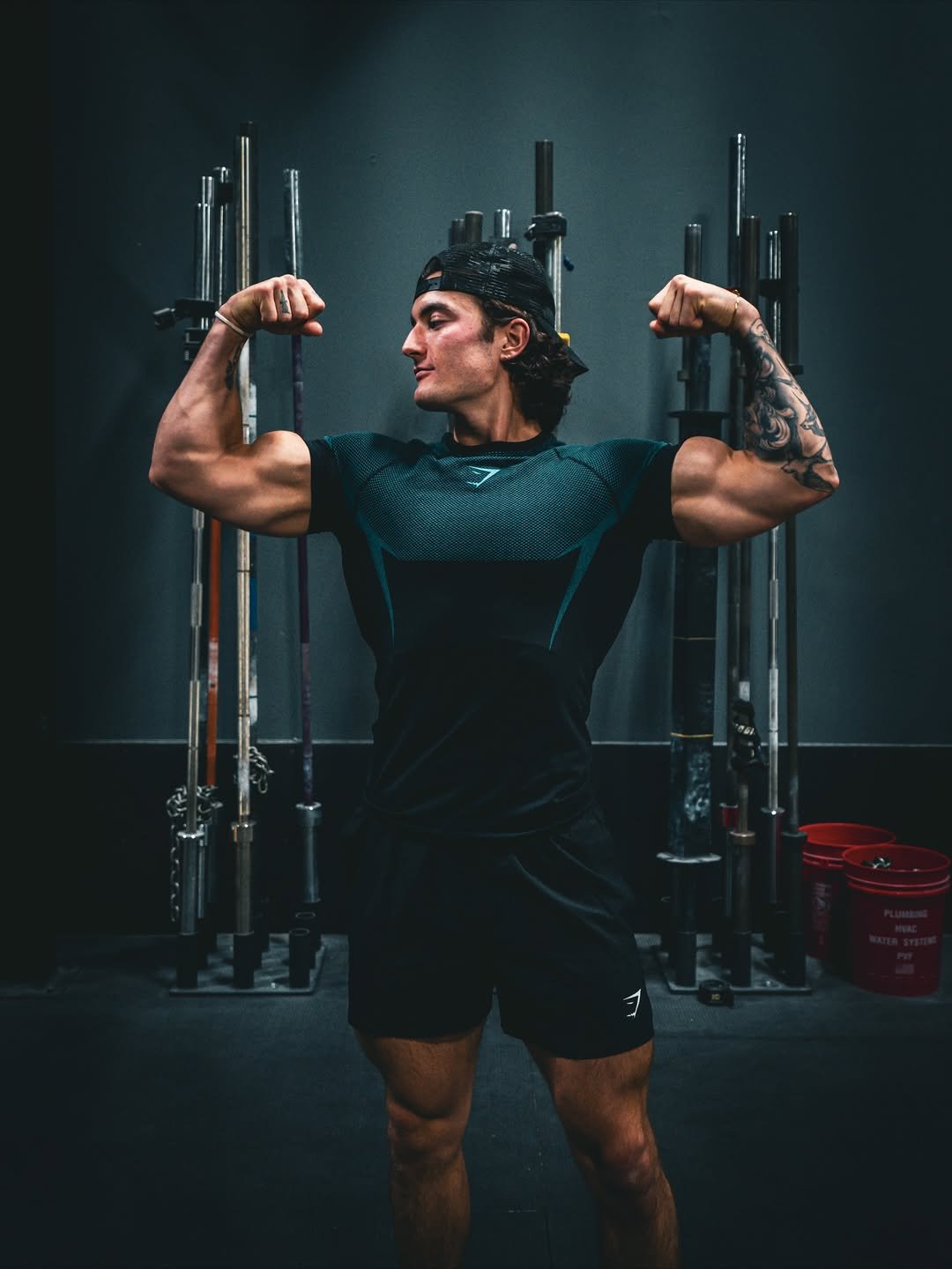 Photo by Jesse James West on November 20, 2025. May be an image of one or more people, biceps, people bodybuilding, activewear, barbell, sportswear and text.