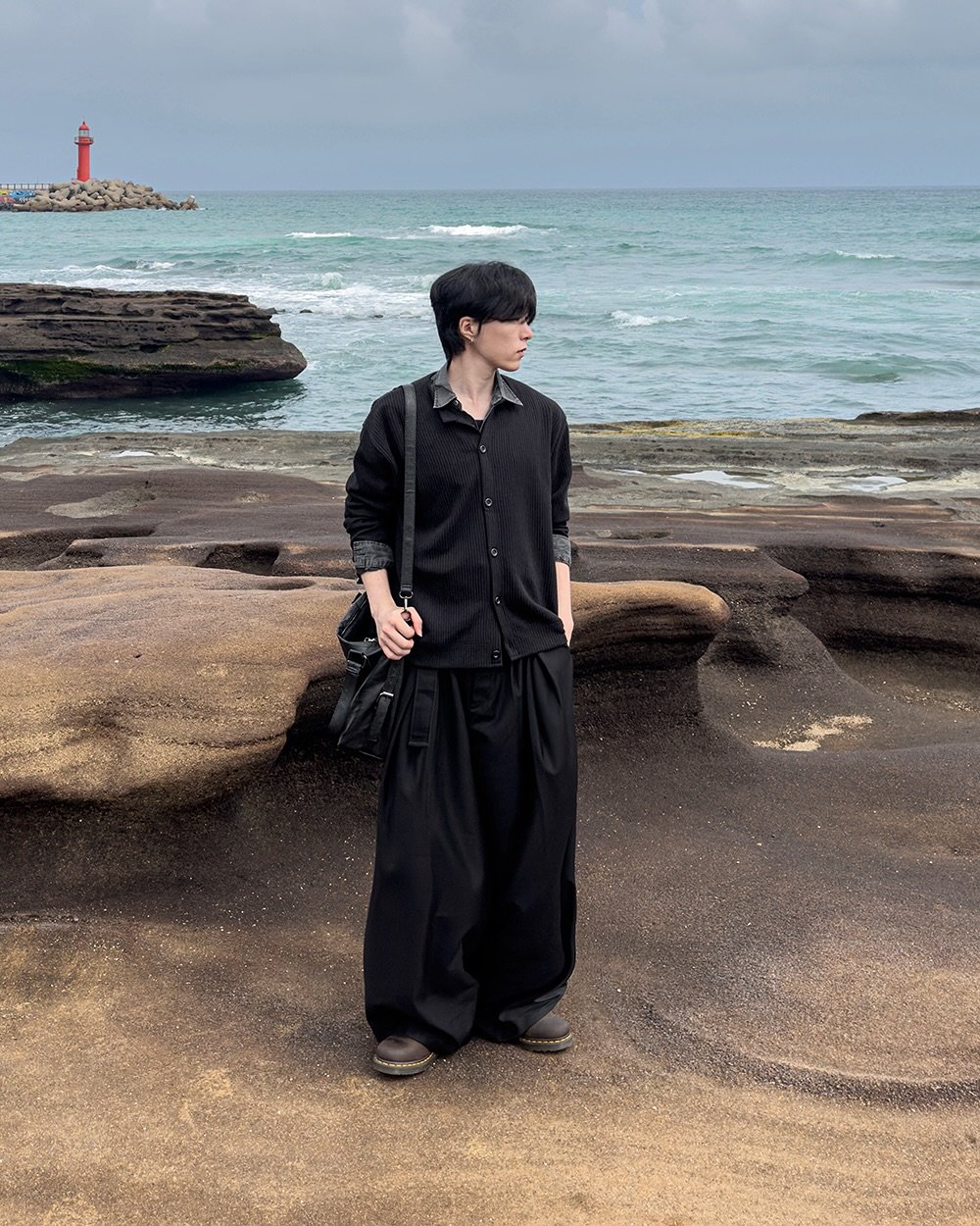 Photo by 지금JIIGEUM🍁 on September 07, 2025. May be an image of 1 person, duffle coat, kilt, ocean, coast and text.