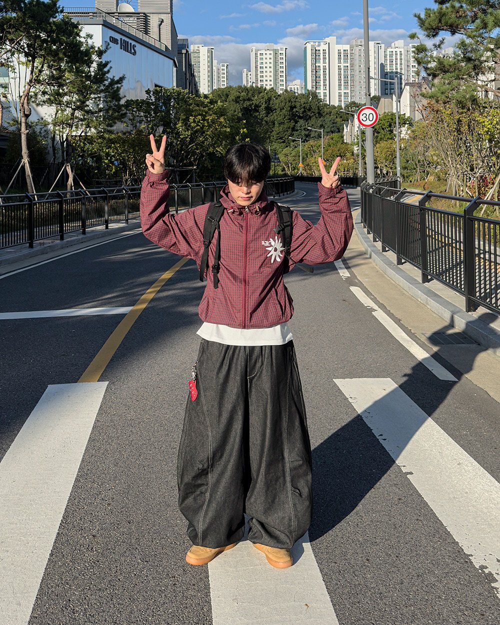 Photo by 지금JIIGEUM🍁 on September 23, 2025. May be an image of 1 person, sarong, street, road and text.