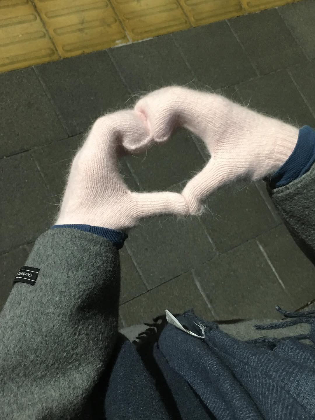 Photo by 백지헌 on February 15, 2026. May be an image of duffle coat, heart, wool, parka, knit and text.