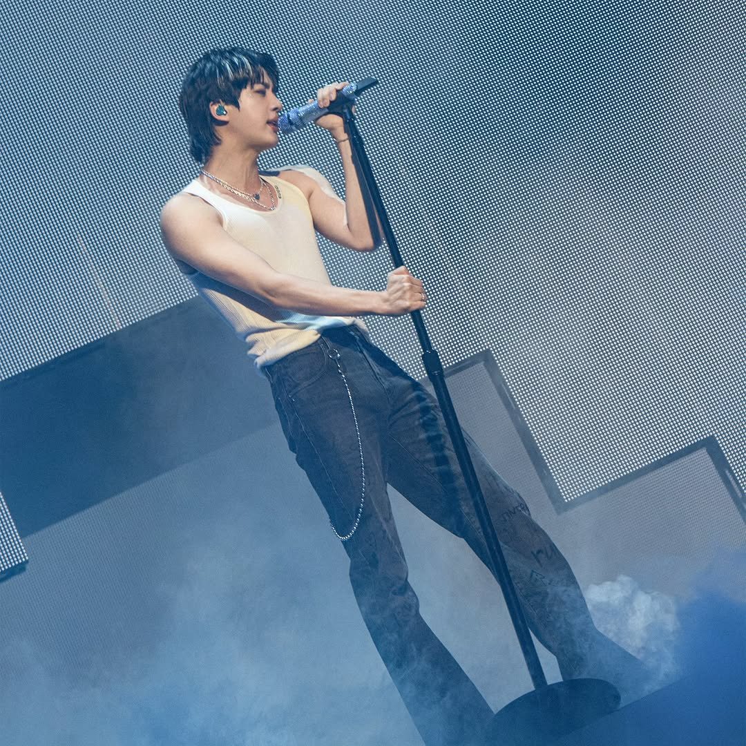 Photo by Jin of BTS on September 07, 2025. May be an image of one or more people, biceps and concert.