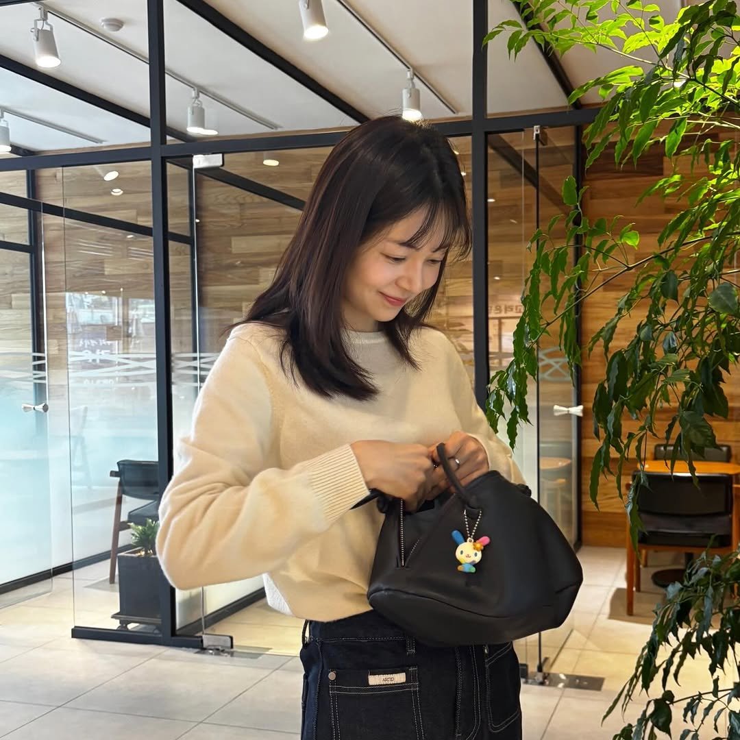 Photo shared by Baek jinhee💕 on February 27, 2026 tagging @artid_official, and @hyyet_. May be an image of purse, sling, briefcase and text.