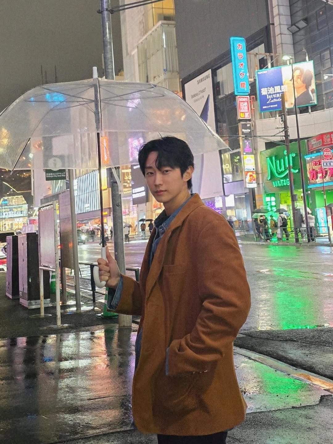 Photo by b1a4 jinyoung on February 28, 2026. May be an image of duffle coat, overcoat, umbrella, parka, raincoat and text.