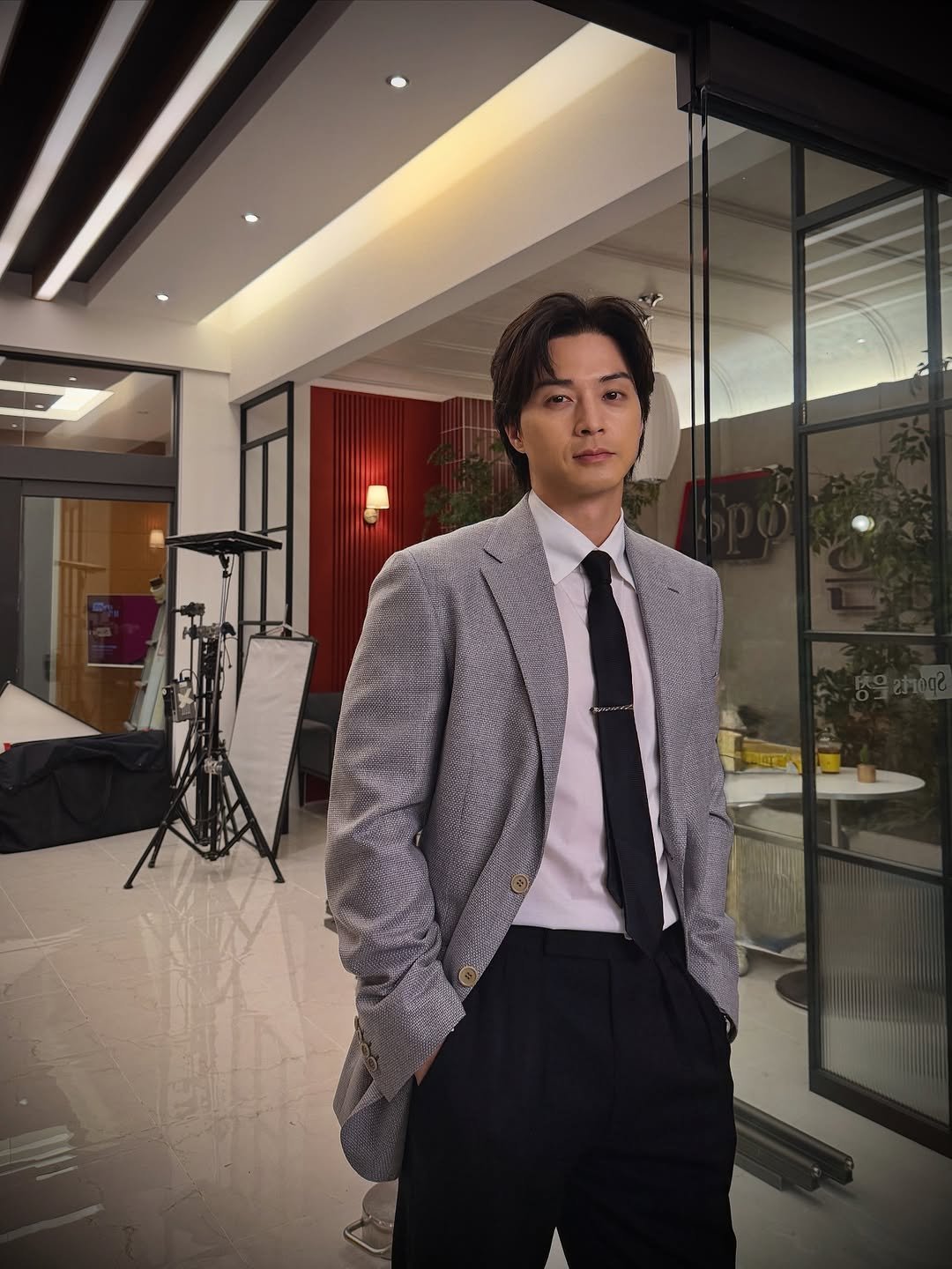 Photo shared by KIM JIHUN on October 25, 2025 tagging @brioni_official. May be an image of one or more people, bangs, suit, blazer, top, dinner jacket, bolo tie and text.