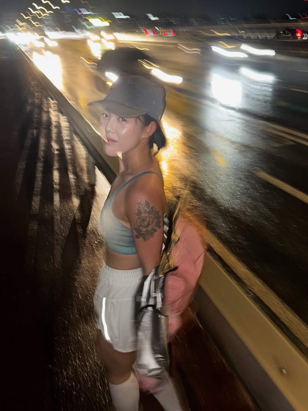 Photo by 지우렐라 on September 12, 2025. May be an image of 1 person, hat, miniskirt, road, street, night and text.