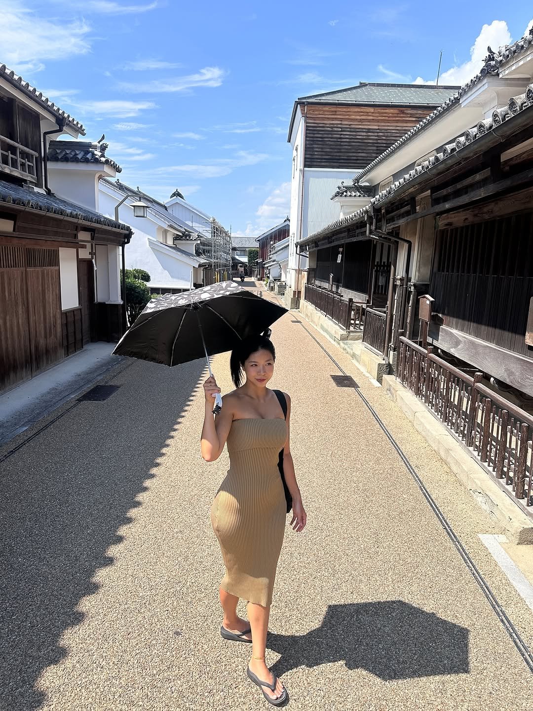 Photo by 제이제이 | 박지은 on September 19, 2025. May be an image of 1 person, umbrella, parasol, sundress, sarong and text.