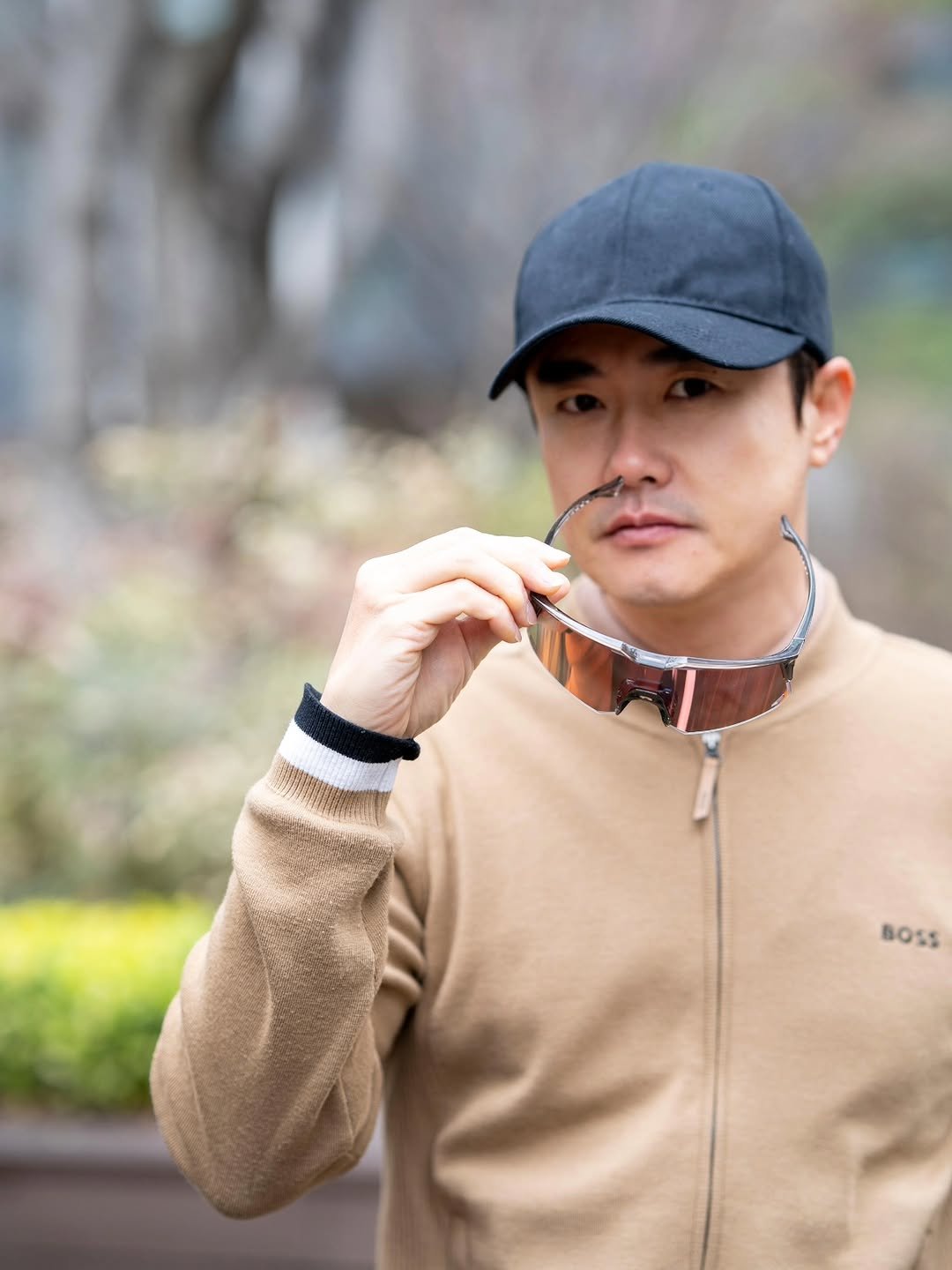 Photo shared by 신 정 균 on March 02, 2026 tagging @wing_kr. May be an image of duffle coat, hat, bolo tie, outdoors and text.