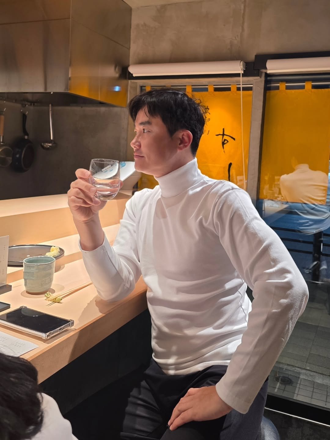 Photo shared by 신 정 균 on February 02, 2026 tagging @sushi_ta2. May be an image of drink, turtleneck and text.