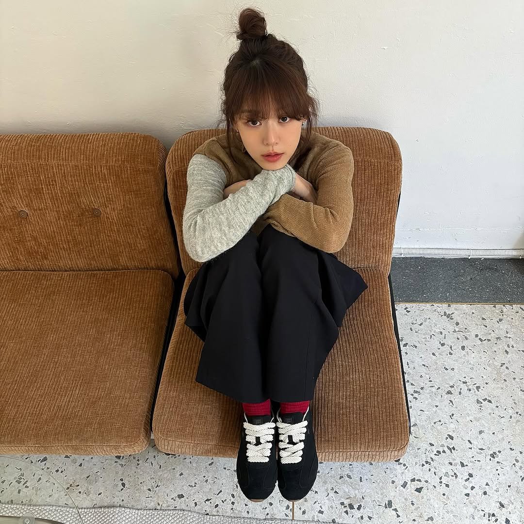 Photo shared by 이주명 on February 09, 2026 tagging @fila_korea. May be an image of one or more people, bangs, duffle coat, sweatpants, turtleneck and text.