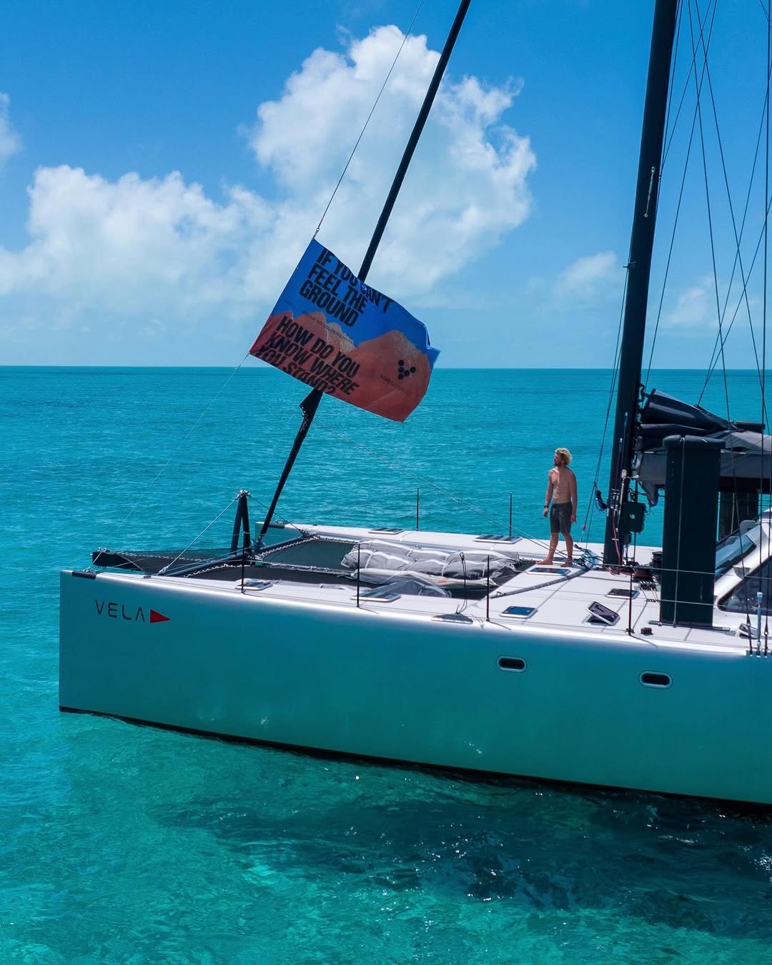 Photo shared by John john Florence on April 18, 2026 tagging @vivobarefoot. May be an image of boat racing, sailboat, sail, yacht, speedboat and text that says 'VELAD'.