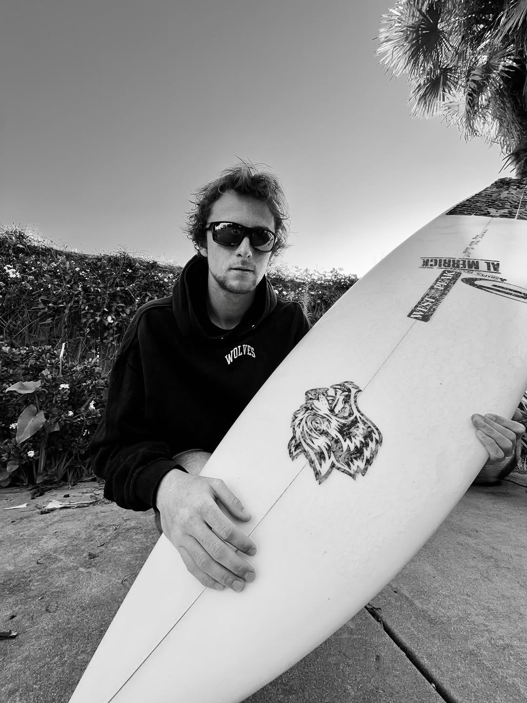 Photo shared by John Mel on February 12, 2026 tagging @darcsportathletics. May be a black-and-white image of surfboard, skateboard, eyewear, wetsuit, water and text.