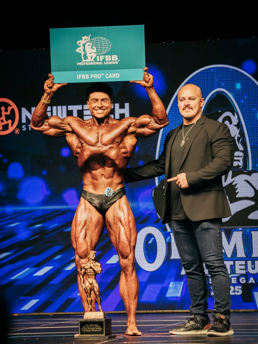 Photo by Johny Münster | The German Phoenix 🐦‍🔥 on October 09, 2025. May be an image of 2 people, biceps, people bodybuilding and text that says 'LIFBB PROFESSIONAL LEAGUE IFBB IFBBPROCARD PRO™ CARD H H 252 আপ Οι 手 ส И TEU EGA 25 H ブン'.