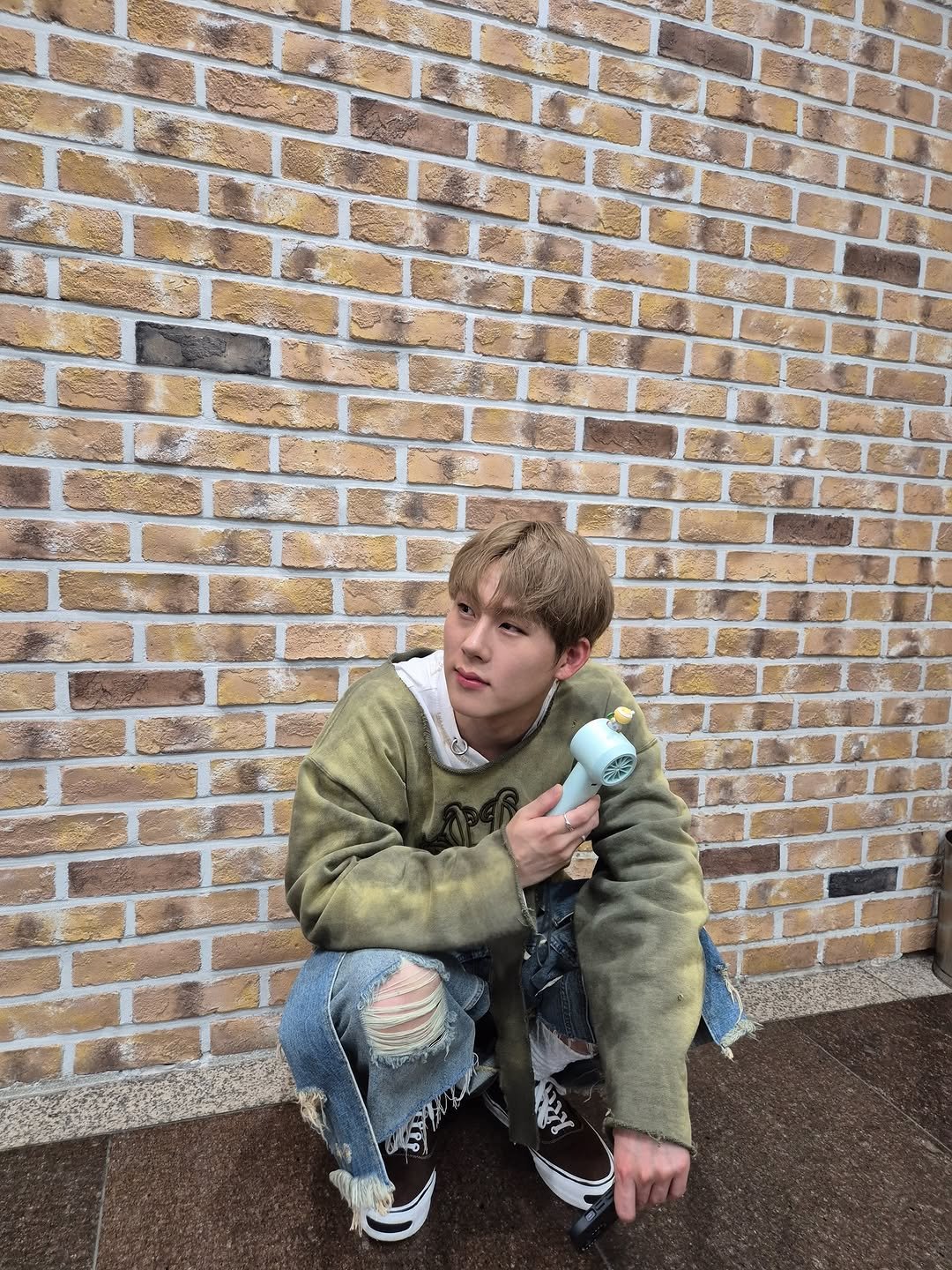 Photo by 주헌 joohoney on September 14, 2025. May be an image of one or more people, bangs, parka and brick wall.