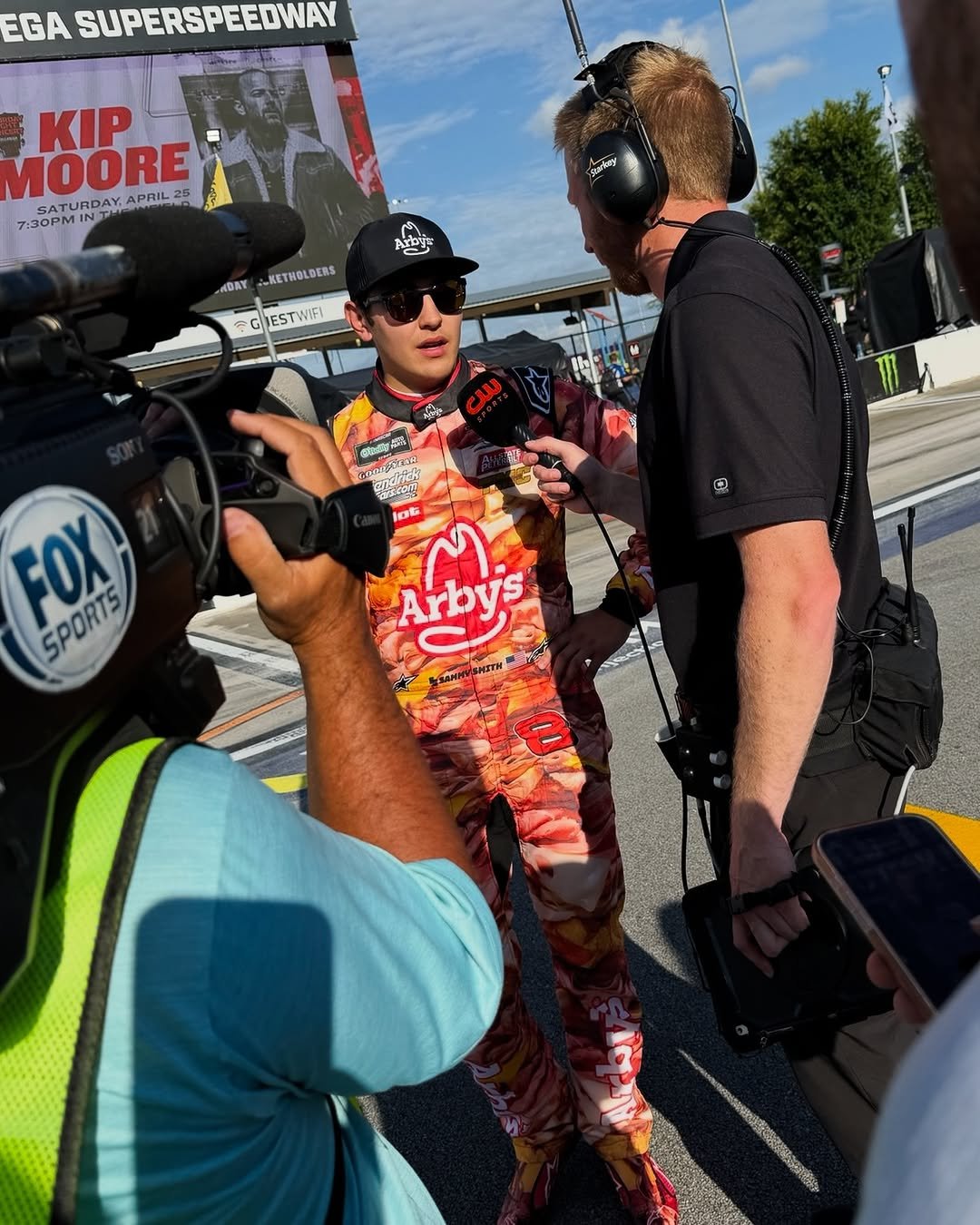 Photo shared by Sammy Smith on April 25, 2026 tagging @arbys, @oakley, @jrmotorsports, @alpinestars, @pilotflyingj, @allstatepeterbiltgroup, @oakleymotorsports, @tmc_trans, and @alpinestarsauto. May be an image of ‎racing vehicles and ‎text that says '‎EGA SUPERSPEEDWAY KIP MOORE SATURDAY. APRIL25 :30PM Saprlny צזיו DAY KETHOLDERS GIESTWIFI 之味 لى FOX SPORTS SPORTS ซนลาก lot ጣ Arbys KmaHHи3иrTH 8‎'‎‎.